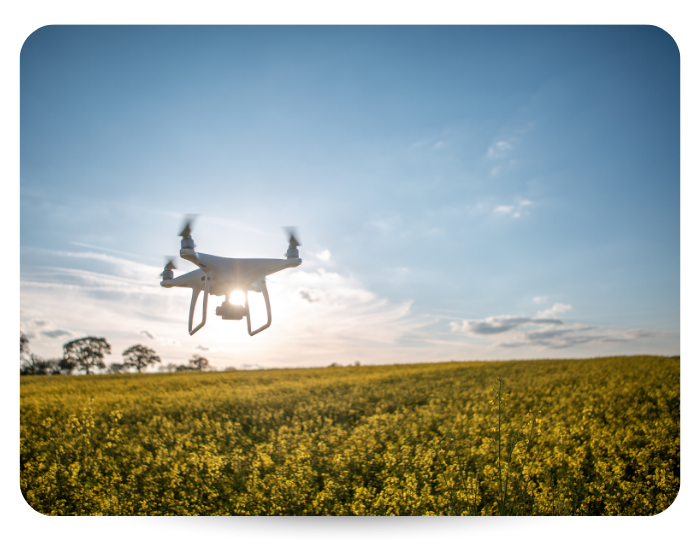 agricultural drone spraying over an open field 